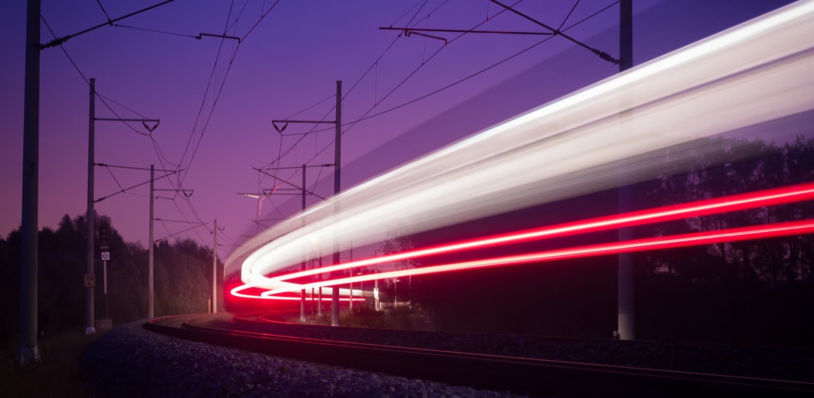 Electric freight train and HGV at a logistics hub